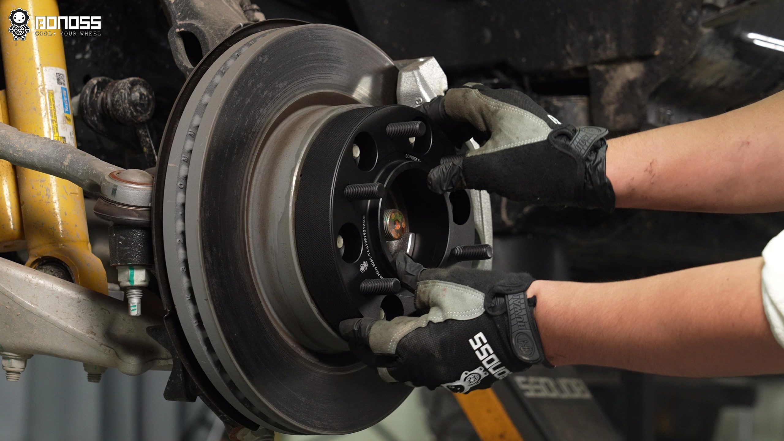 BONOSS Forged Active Cooling Hubcentric Bronco Wheel Spacers Installation Steps (3) A man is putting a Bronco wheel spacer on the wheel hub
