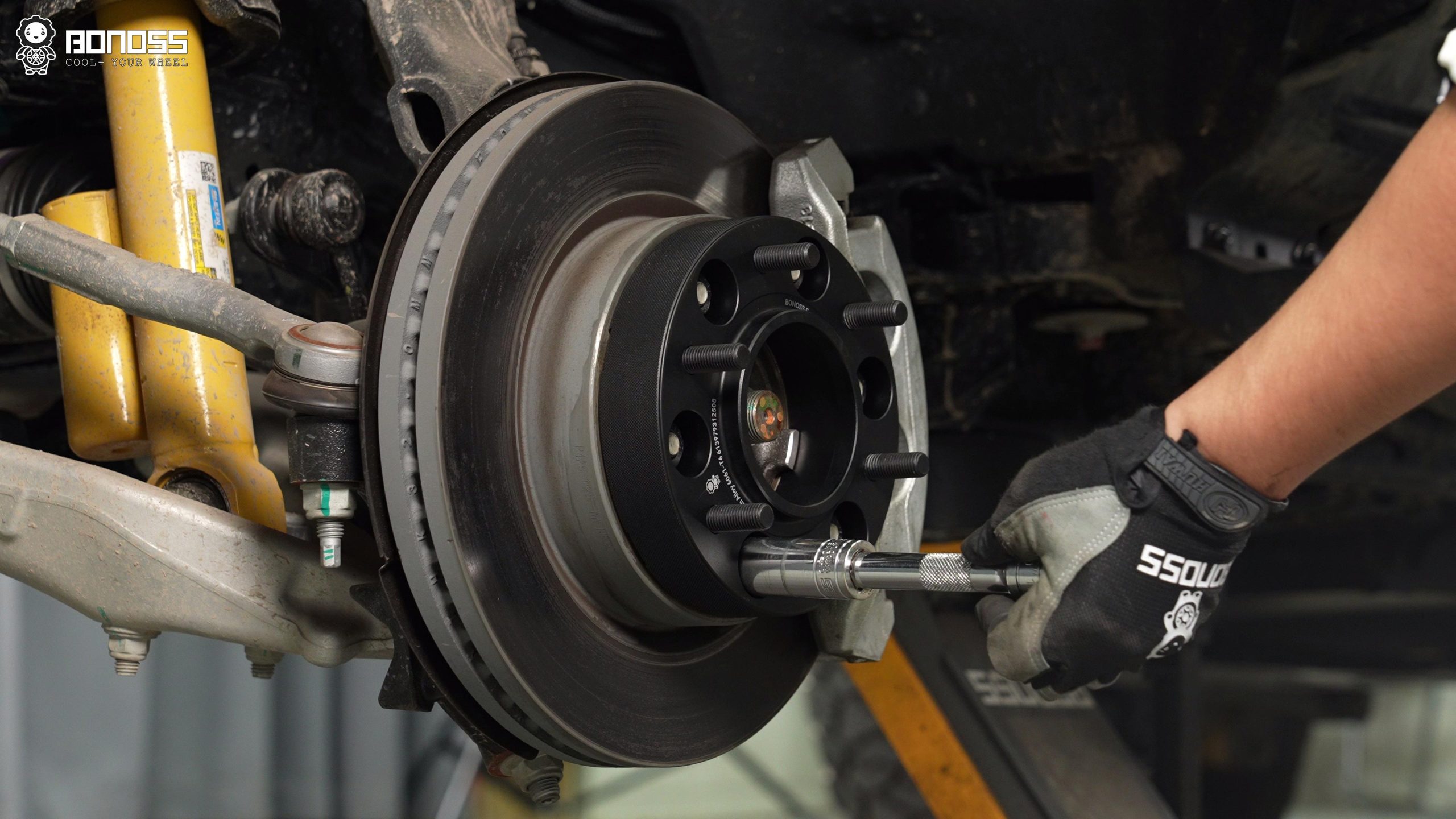 BONOSS Forged Active Cooling Hubcentric Bronco Wheel Spacers Installation Steps (4) A man is torquing a Bronco wheel spacer on the wheel hub