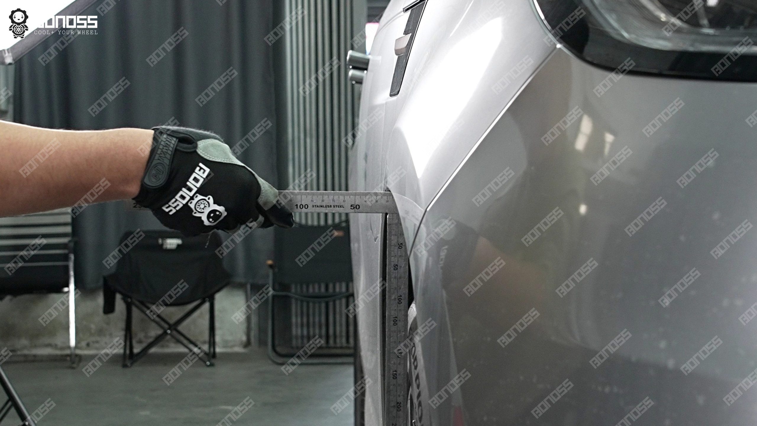 2026-land-rover-range-rover-sport-flush-measurement-front-left-ruler High-accuracy ruler measuring front-left flush gap on a 2026 Land Rover Range Rover Sport before wheel spacer install