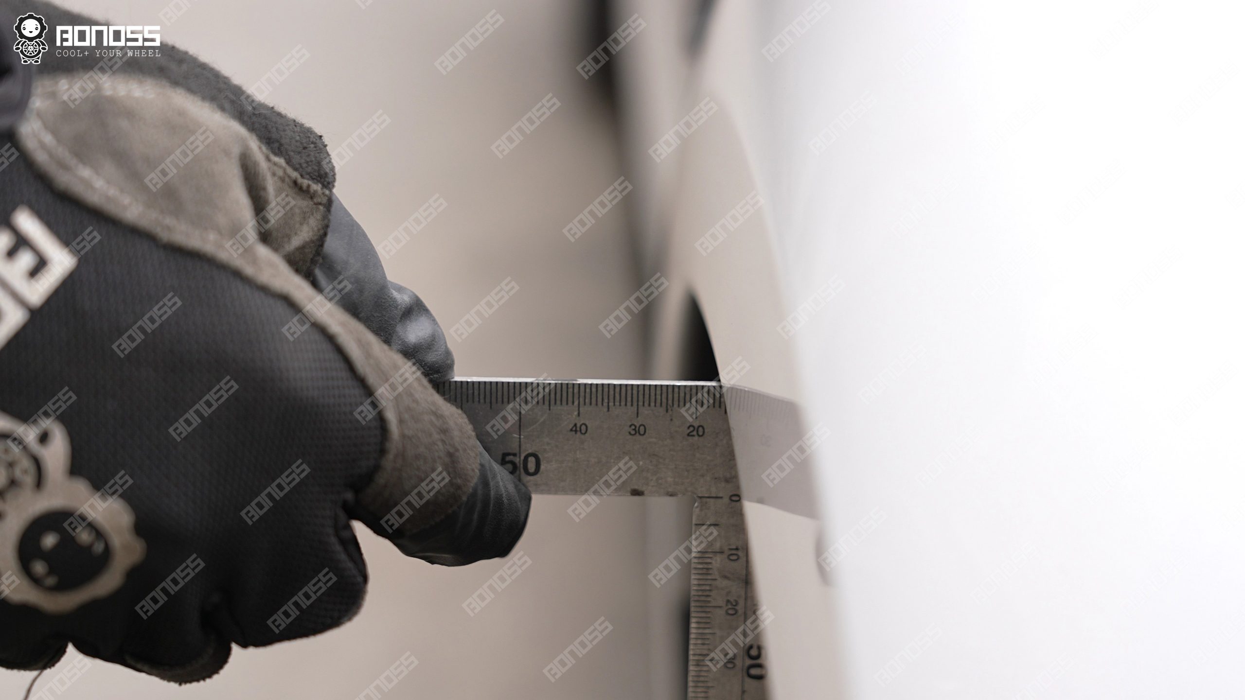 High-accuracy ruler measuring front-left flush gap on a 2021 BMW M3 G80 before wheel spacer install High-accuracy ruler measuring front-left flush gap on a 2021 BMW M3 G80 before wheel spacer install