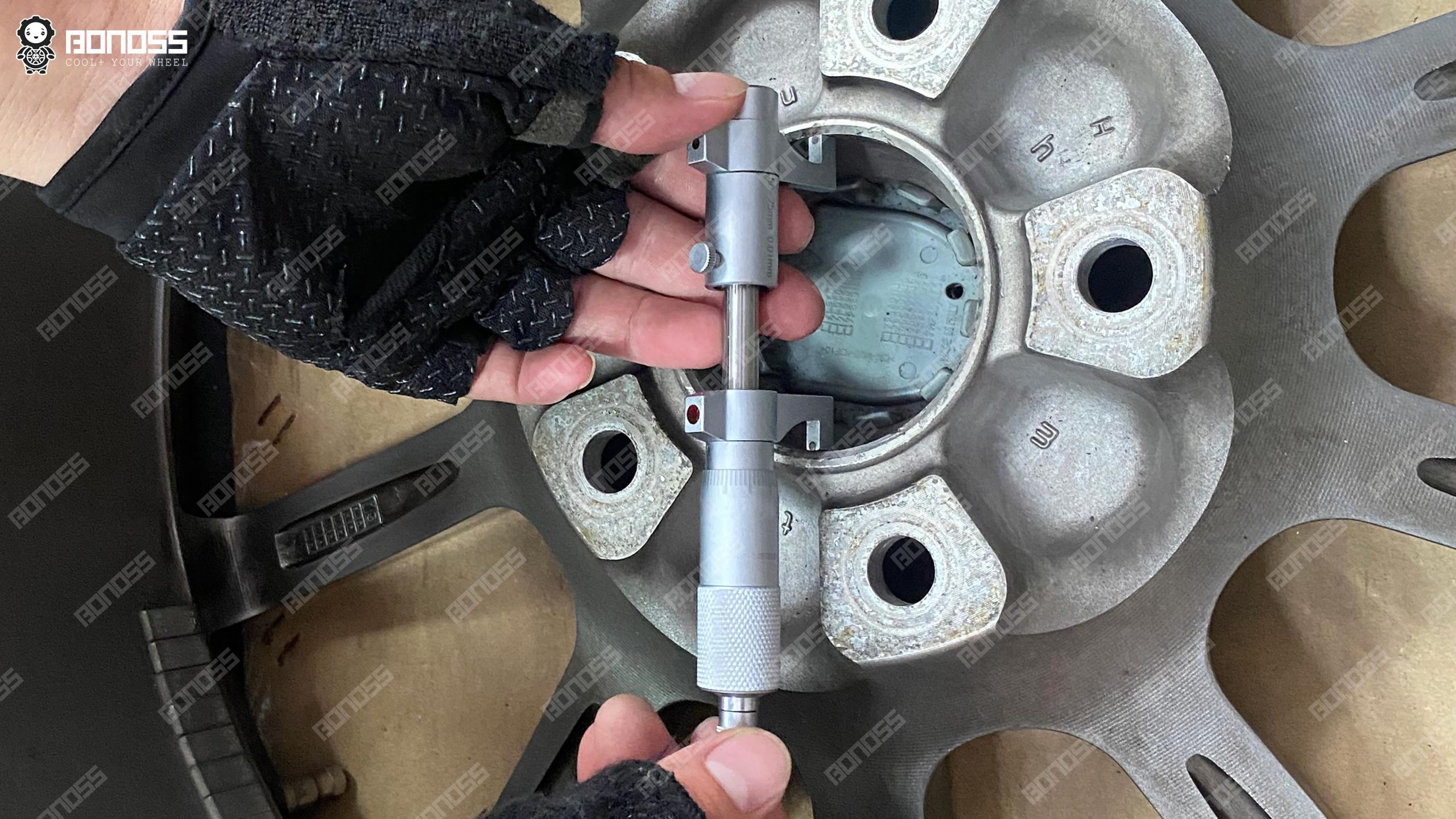measuring-wheel-center-bore-micrometer Micrometer measuring an aftermarket wheel center bore for wheel spacer fitment