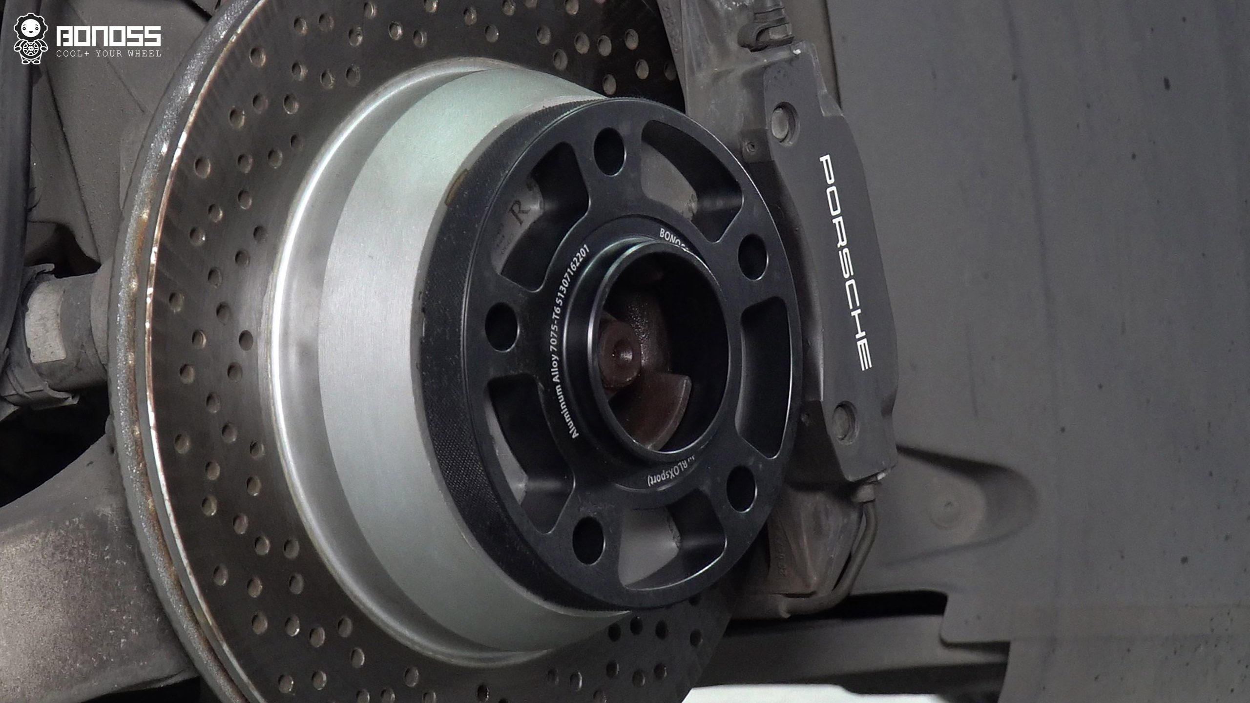 wheel-spacer-seated-on-porsche-hub Hub-centric wheel spacer seated on a Porsche Cayman hub showing multi-stage centering