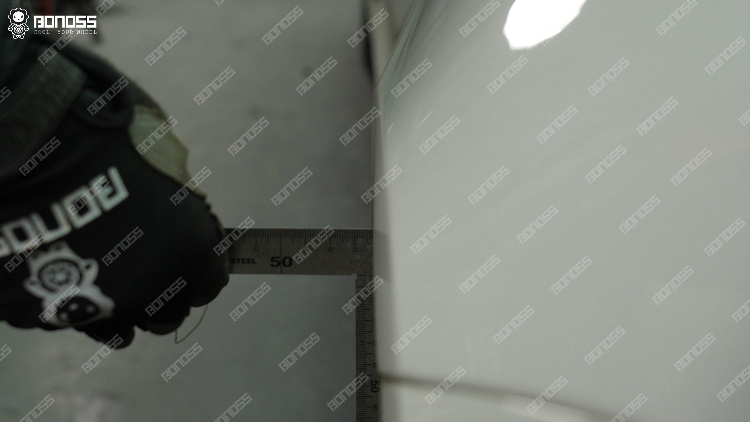 2023-porsche-taycan-front-left-fender-gap-ruler-measurement Ruler measuring front fender gap on the 2023 Porsche Taycan for 15mm sizing.