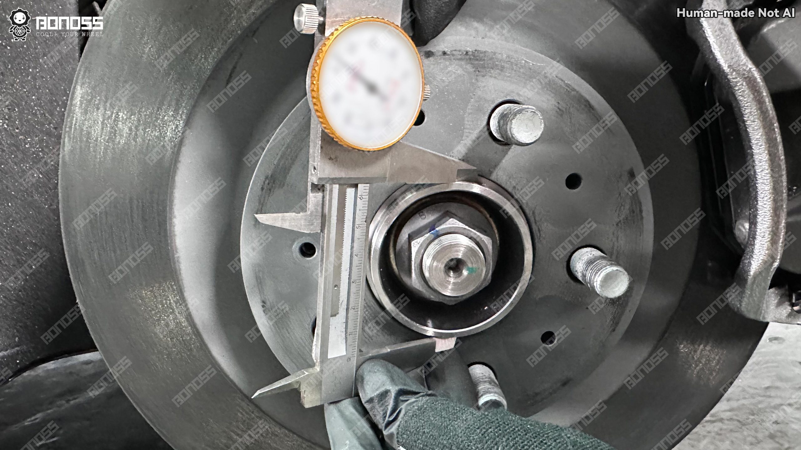 2023-tesla-model-3-hubcentric-wheel-spacers-oem-hub-bore-check Original hub diameter inspection supporting 2023 Tesla Model 3 hubcentric wheel spacers centering.