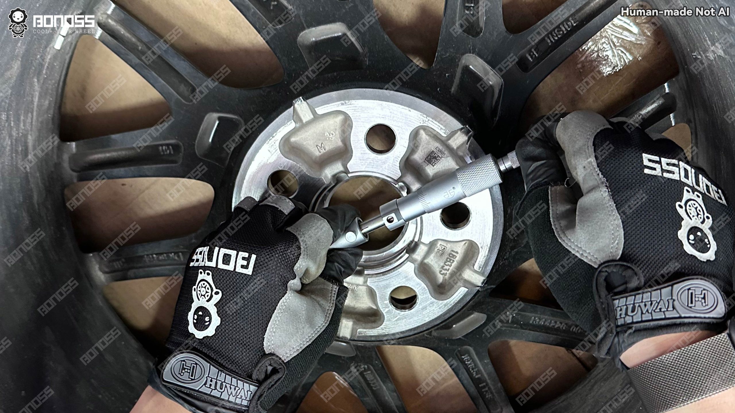 2023-tesla-model-3-hubcentric-wheel-spacers-wheel-bore-measurement Micrometer inspection of the wheel center bore for 2023 Tesla Model 3 hubcentric wheel spacers matching.