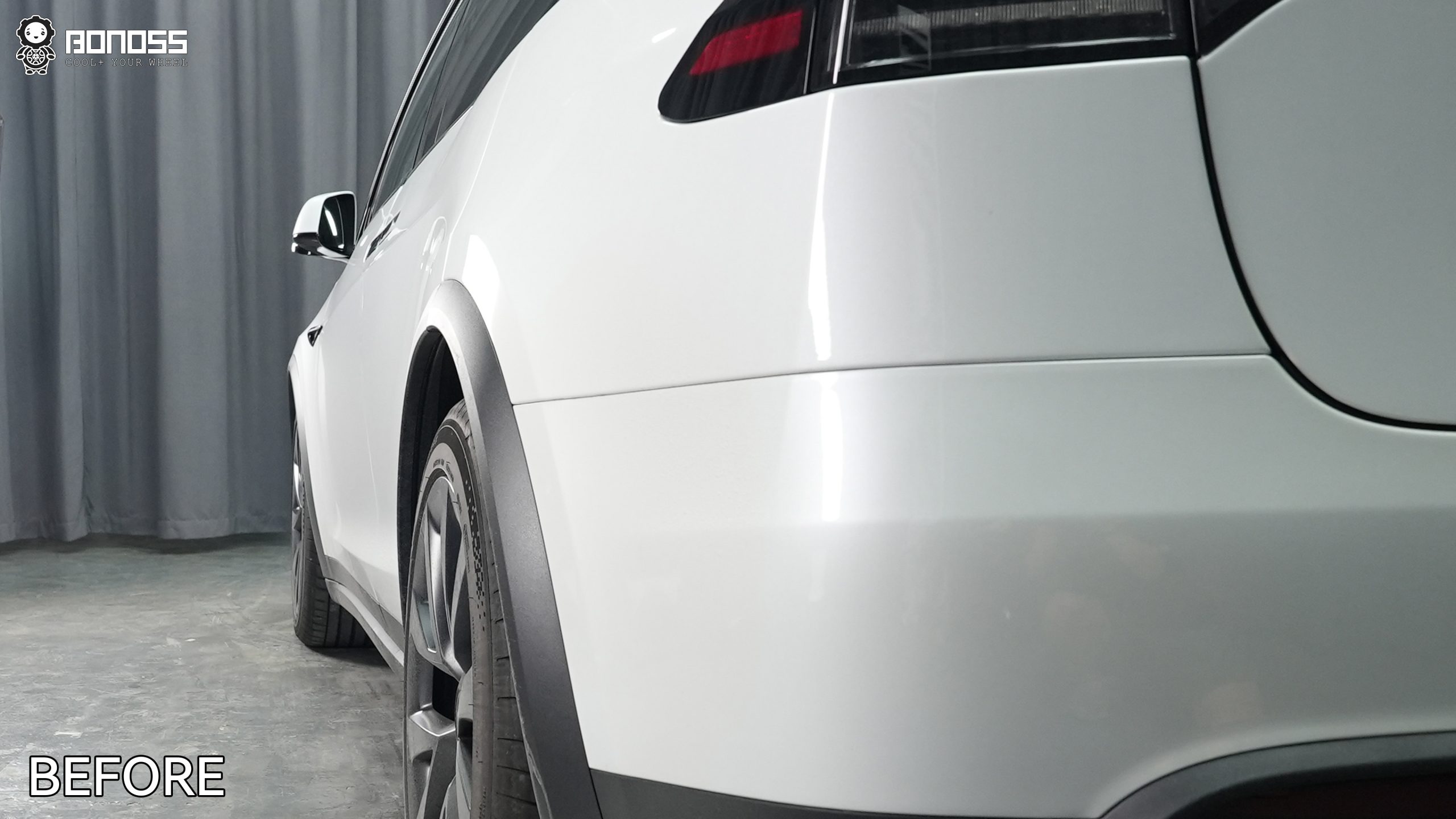 2023-tesla-model-x-left-rear-wheel-before-adding-20mm-spacer Factory left rear wheel tucked inside the fender of a 2023 Tesla Model X.