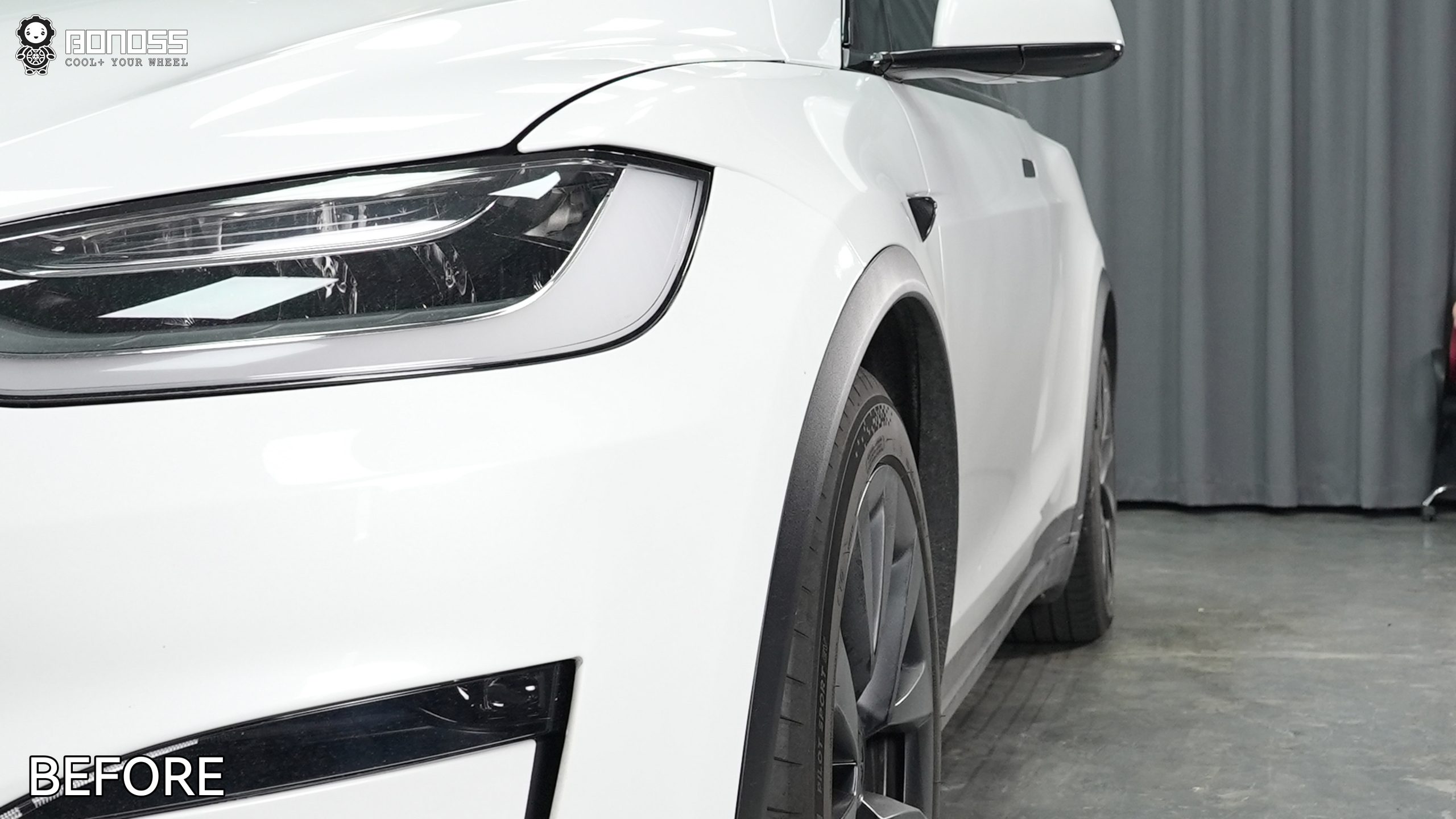 2023-tesla-model-x-right-front-wheel-in-stock-tucked-position Stock right front wheel sitting recessed on a 2023 Tesla Model X before modifications.