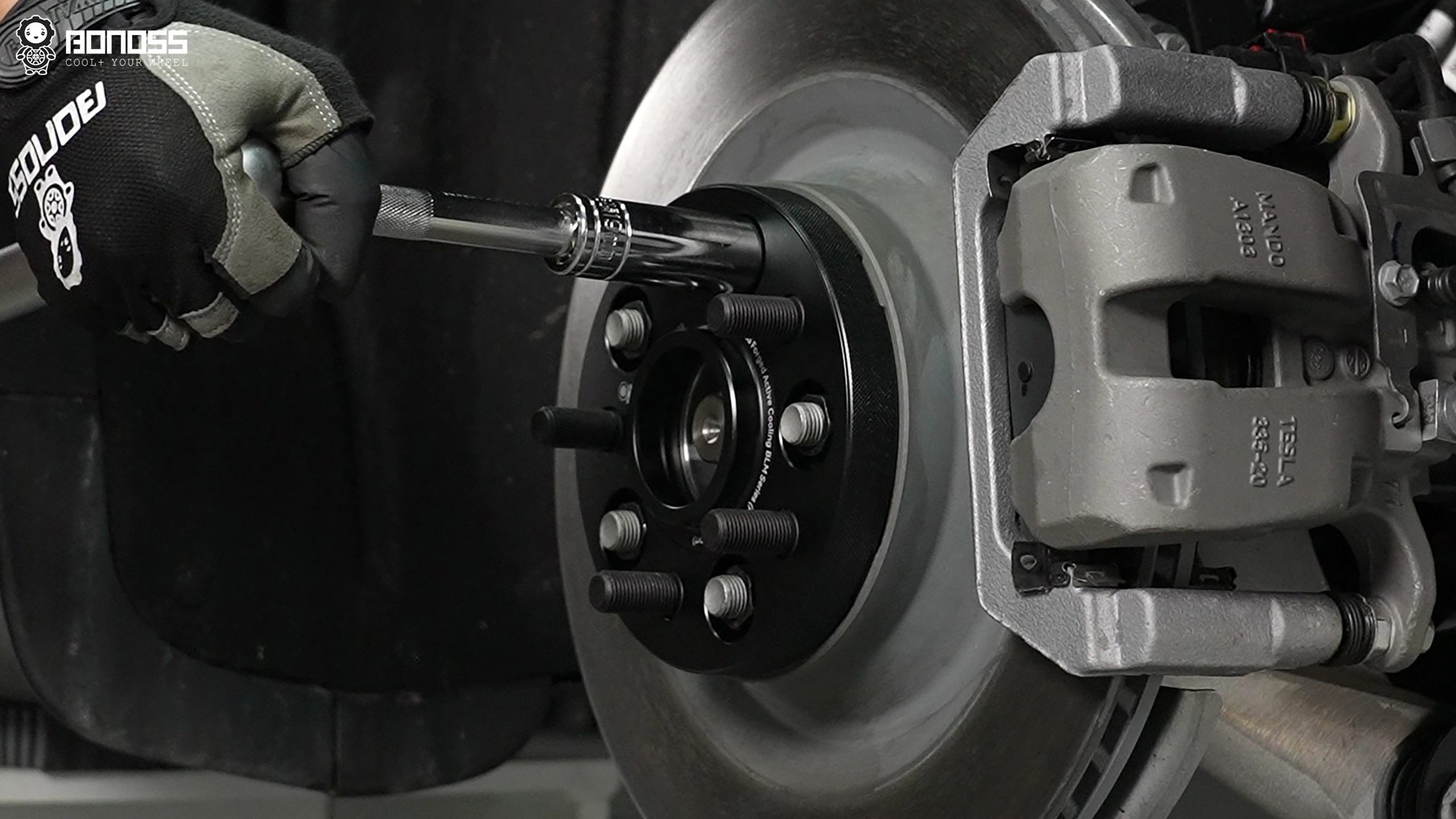 bonoss-wheel-spacers-tesla-model-y-torque-wrench-installation BONOSS forged wheel spacer installed on the Tesla Model Y hub, being torqued with a torque wrench to specification