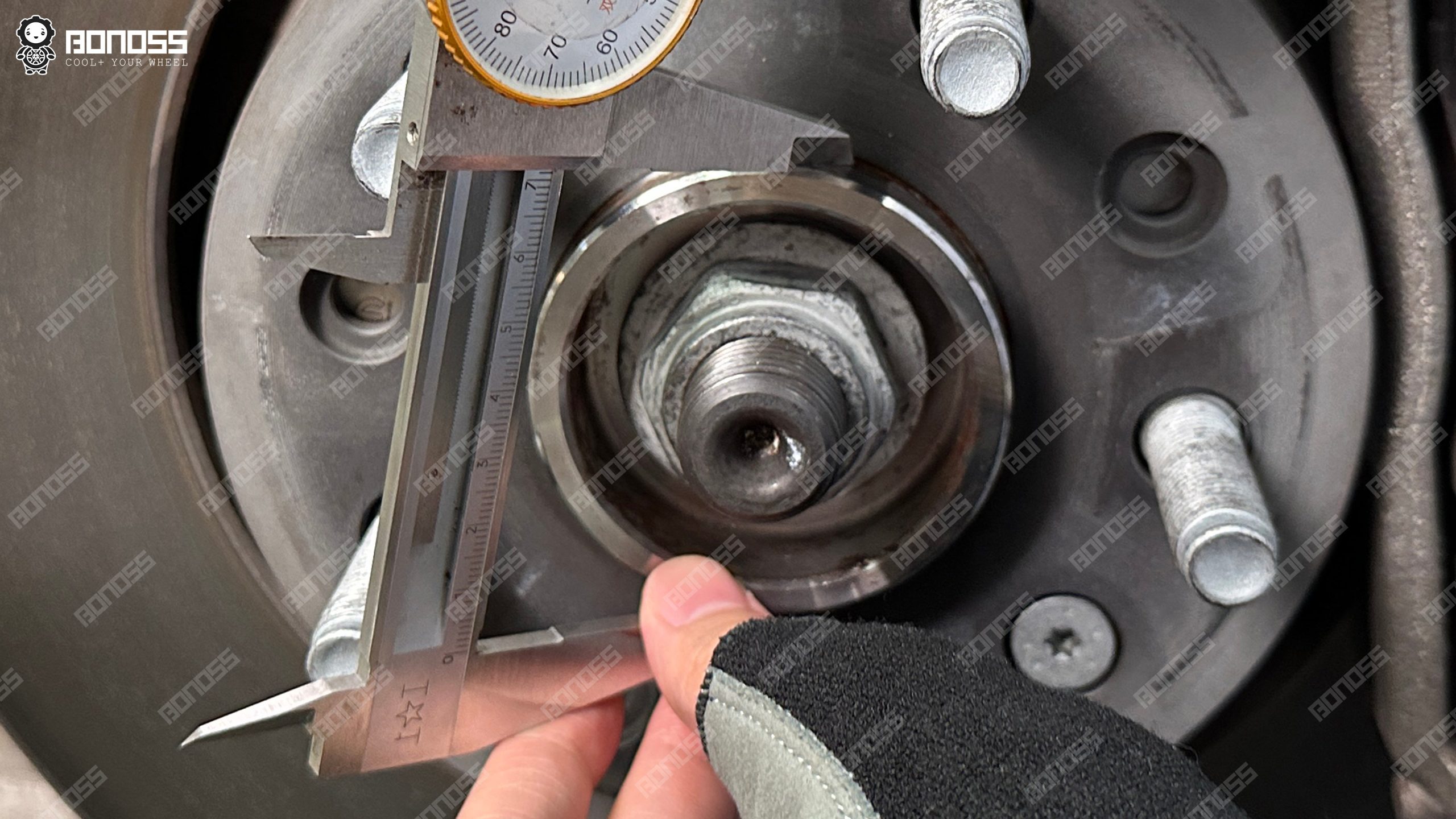 caliper-measures-hub-center-bore-diameter-2021-jeep-wrangler Measuring jaws inside the hub bore of a Wrangler JL Rubicon to confirm the centering register diameter before machining spacers.