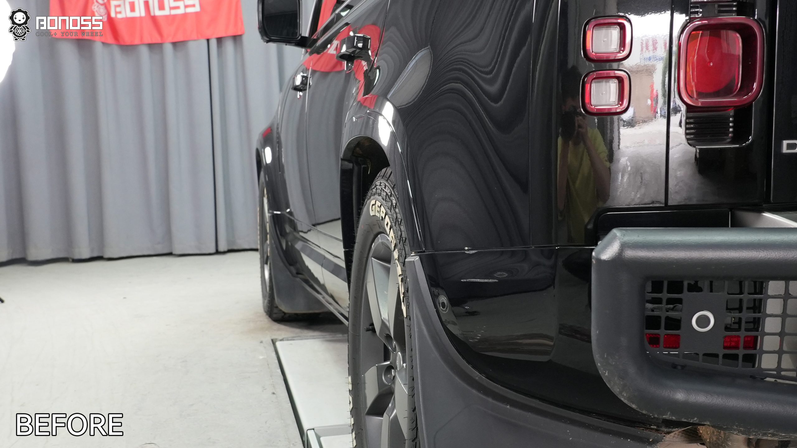defender-5×120-wheel-spacers-left-rear-wheel-before-tucked-tire Rear tire tucked inward behind the wheel well edge on a truck before Defender 5x120 wheel spacers address the stance.