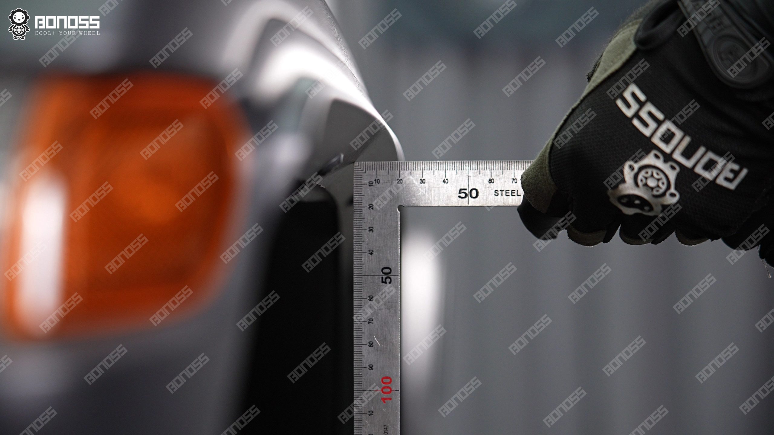 high-accuracy-ruler-measures-right-front-wheel-flush-on-wrangler-jl Measuring tool held at the right front wheel of a 2021 Jeep Wrangler to determine the flush spacer thickness needed.
