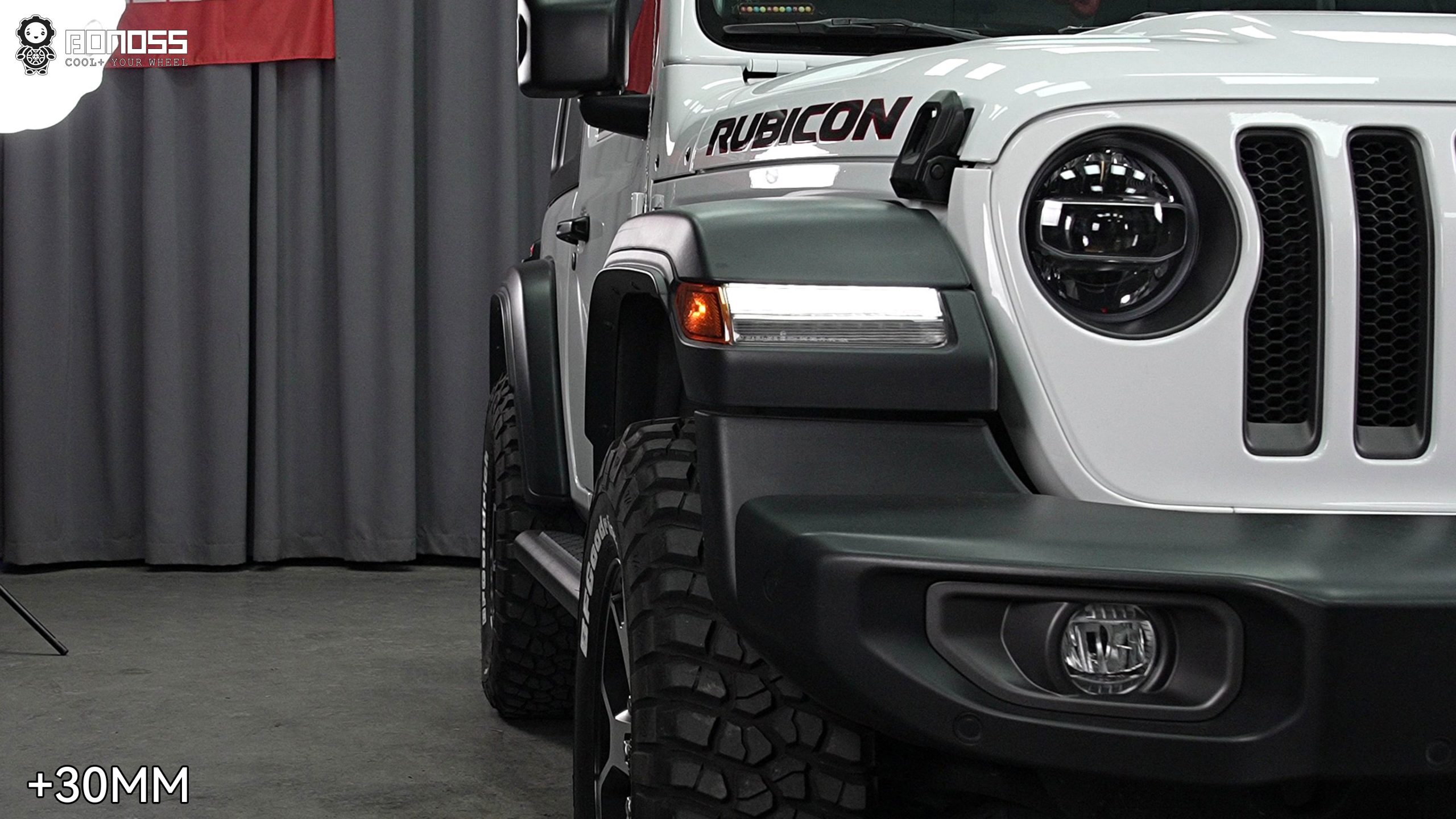left-front-wheel-after-30mm-spacers-jeep-wrangler-jl Modified left front corner of a 2021 Wrangler Rubicon showing the tire pushed out to a flush stance.