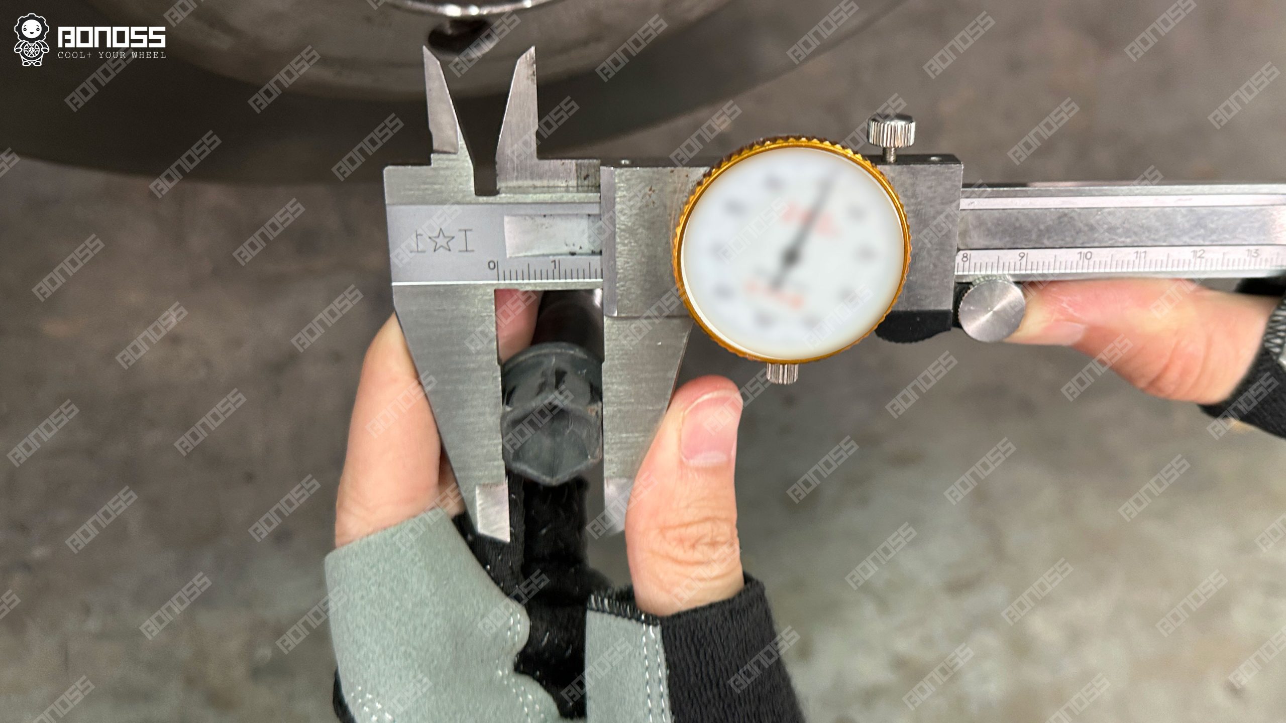 measuring-oem-bolt-17mm-hex-on-2021-mercedes-benz-e-class Vernier caliper confirming the 17mm hex head size of a factory 2021 Mercedes-Benz E-Class wheel bolt.