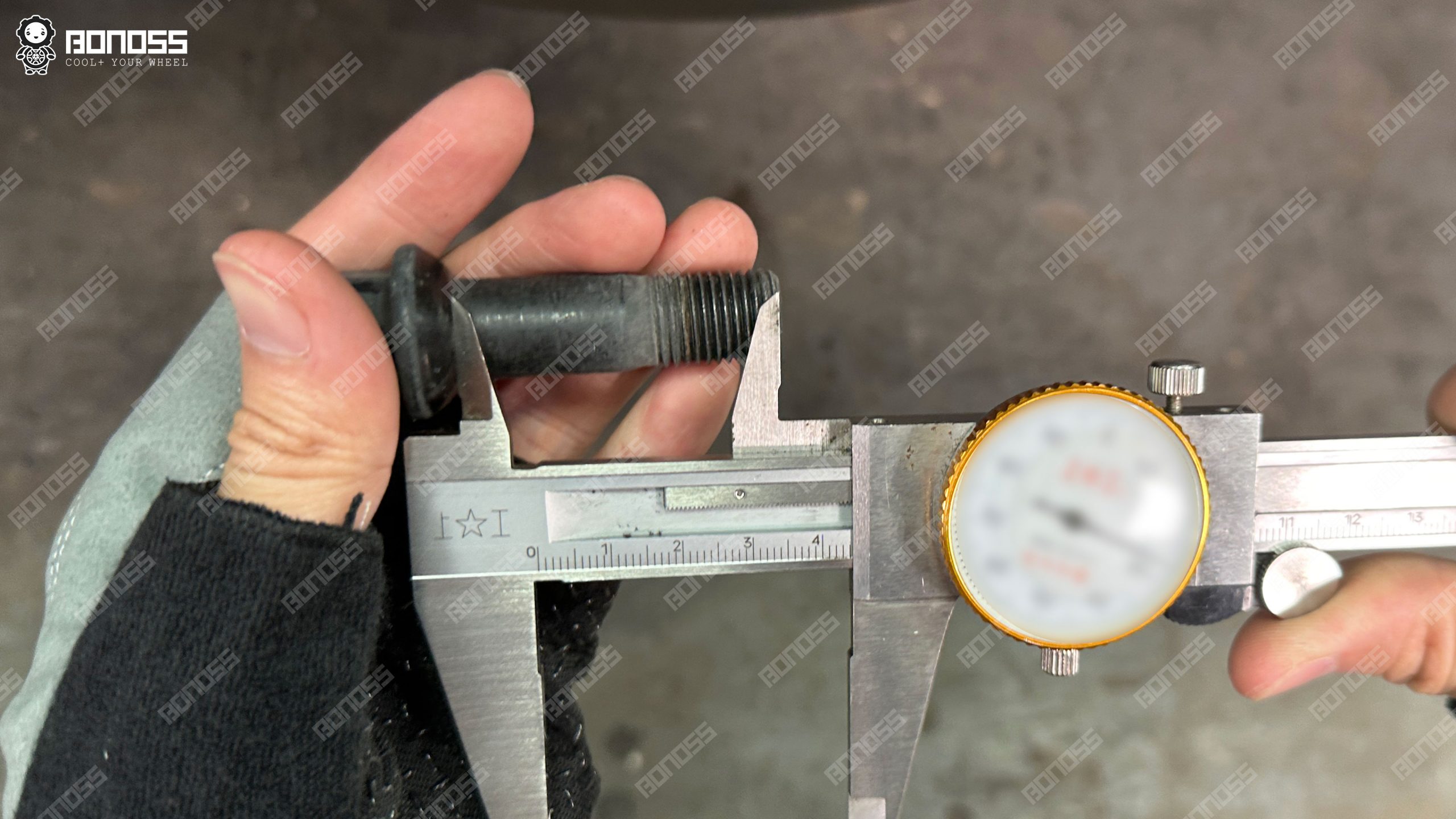 oem-bolt-thread-length-check-2021-mercedes-benz-e-class-15mm-spacers Factory R14 ball-seat bolt measured at 45mm thread length for a 2021 Mercedes-Benz E-Class 15mm spacers setup.