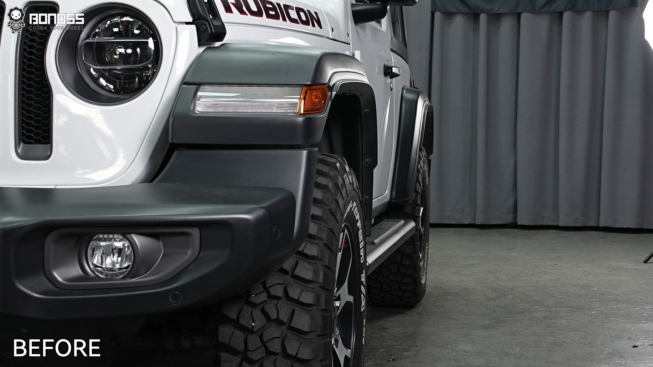 right-front-fender-gap-before-spacers-on-wrangler-jl Unmodified right front corner of a 2021 Jeep Wrangler Rubicon showing stock wheel inset before spacer fitment.