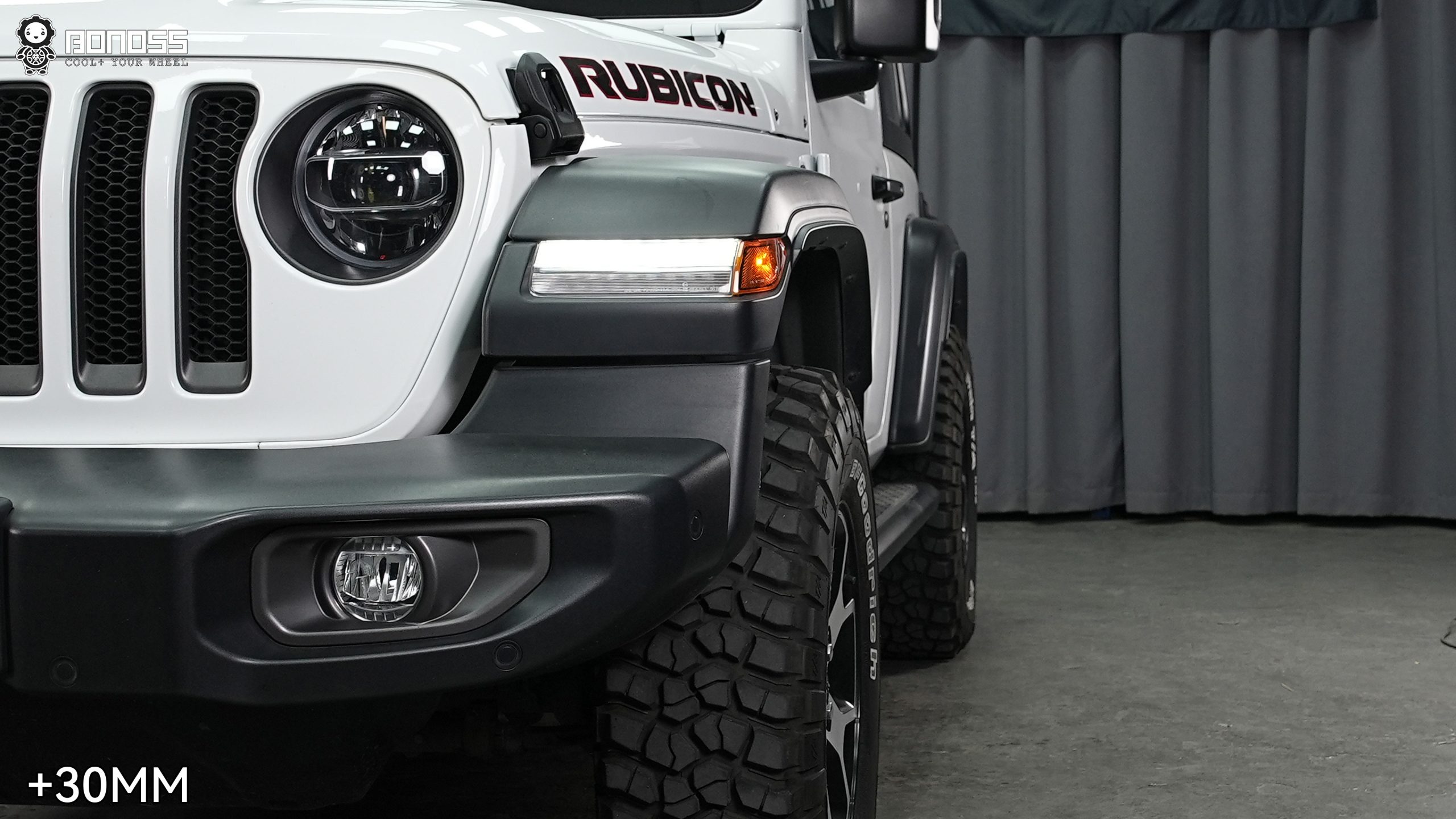 right-front-wheel-flush-after-30mm-spacer-2021-wrangler Completed right front corner of a Jeep Wrangler JL Rubicon with the wheel brought out flush against the fender line.