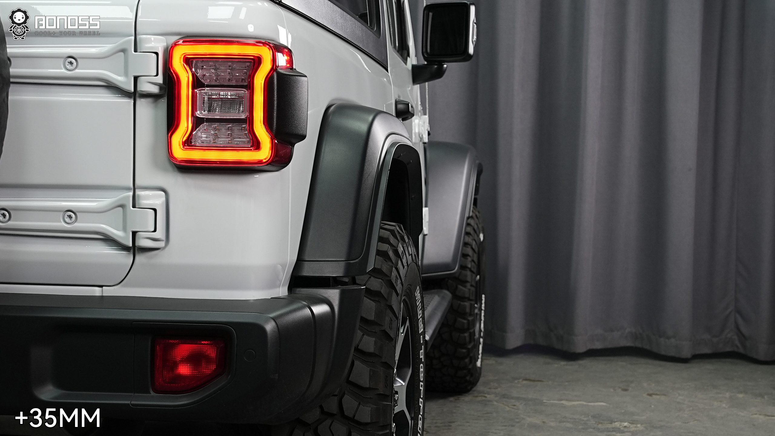 right-rear-wheel-brought-flush-by-35mm-spacer-wrangler-jl Updated right rear corner of a 2021 Jeep Wrangler Rubicon with the wheel pushed out flush against the rear fender.